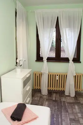 a bedroom with a bed and a window with curtains at Central Charming Home with Garden near Parking and NDK in Sofia