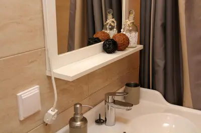 a bathroom with a sink and a mirror at Central Charming Home with Garden near Parking and NDK in Sofia