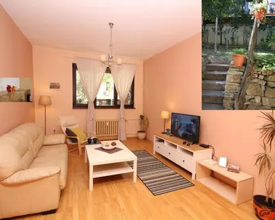 a living room with a couch and a tv at Central Charming Home with Garden near Parking and NDK in Sofia