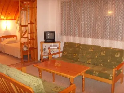 a living room with a couch and a bed at Family Hotel Markony in Pamporovo