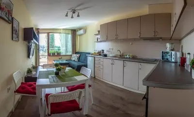 a kitchen and living room with a table and a dining room at RIVERSIDE APARTMENTS PLOVDIV with free parking in Plovdiv