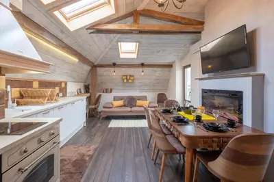 a kitchen and living room with a table and a couch at 2-Bedroom Elegant Apartment in Mediterranean Style in Sofia