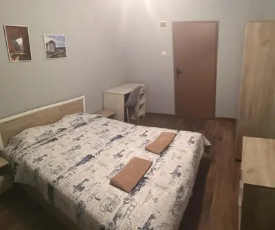 a small bedroom with a bed and a desk at Panorama Rooms in Sofia