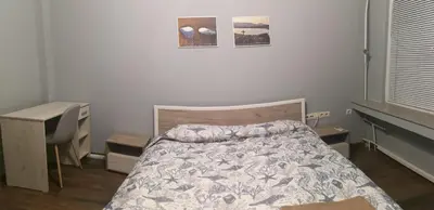 a bedroom with a bed and a desk and a desk at Panorama Rooms in Sofia