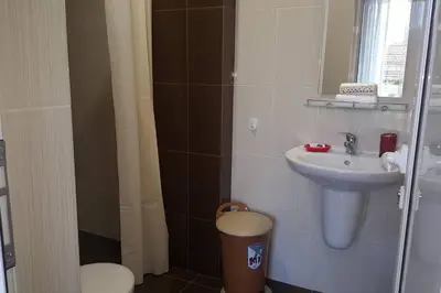 a small bathroom with a sink and a toilet at MARIANA - guest rooms in Gotse Delchev