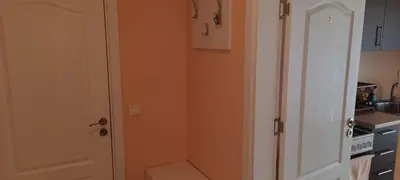 a bathroom with a toilet in the corner of a kitchen at MARIANA - guest rooms in Gotse Delchev