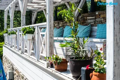 a balcony with plants in pots on it at Chiflika Family Hotel in Asenovgrad