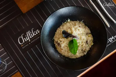 a bowl of rice with a green leaf on top at Chiflika Family Hotel in Asenovgrad