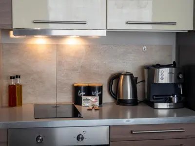 a kitchen with a counter top with a coffee maker at Modern Apartment with Parking next to Bulgaria Mall in Sofia