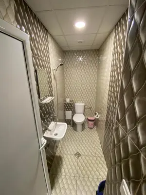 a small bathroom with a toilet and a sink at Apartments DIEM in Samokov