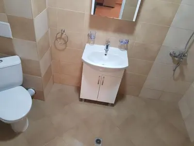 a bathroom with a white toilet and a sink at Twain Apart&Rooms in Sofia