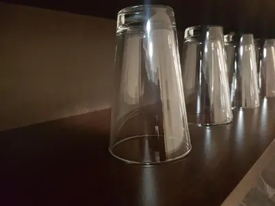 a row of glass bottles sitting on top of a table at Twain Apart&Rooms in Sofia