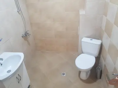 a bathroom with a white toilet and a sink at Twain Apart&Rooms in Sofia