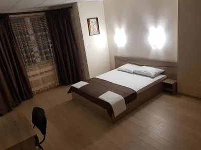 a bedroom with a large bed and a window at Twain Apart&Rooms in Sofia