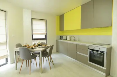 a kitchen with a table and chairs and a dining room at Noris Apart with Garage in Plovdiv