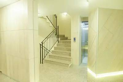 a staircase in a house with a glass wall at Noris Apart with Garage in Plovdiv