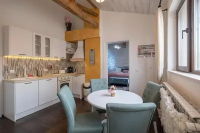 a kitchen and dining room with a table and chairs at 1-Bedroom Designer Apartment on Hristo Belchev Str in Sofia