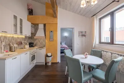 a kitchen with a table and chairs and a dining room at 1-Bedroom Designer Apartment on Hristo Belchev Str in Sofia