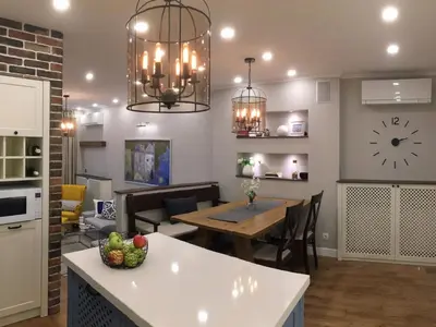a kitchen and dining room with a table and a clock on the wall at A luxury apartment with patio and BBQ in Sofia