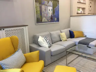 a living room with a couch and two chairs at A luxury apartment with patio and BBQ in Sofia