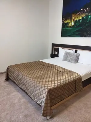 a bedroom with a bed with a large picture on the wall at Central Point Boutique Hotel in Sofia