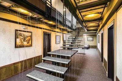 a row of tables in a room with stairs at Central Point Boutique Hotel in Sofia