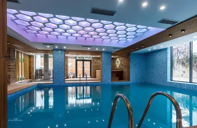 a swimming pool with blue walls and a ceiling at 103 Degrees Hotel & Spa in Sapareva Banya