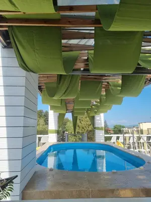 a house with a swimming pool under a roof at 103 Degrees Hotel & Spa in Sapareva Banya