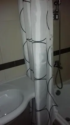 a bathroom with a white shower curtain next to a sink at TES Rila Park Apartments in Borovets