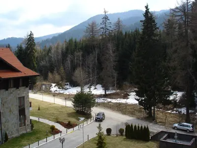 a view of a street with cars parked on the road at TES Rila Park Apartments in Borovets