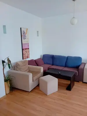 a living room with a blue and purple couch at TES Rila Park Apartments in Borovets