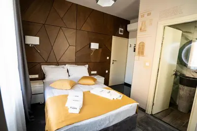 a bedroom with a large bed with two pillows at Boutique Guest house 7th Sense in Plovdiv