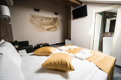 a bedroom with a large bed with yellow pillows at Boutique Guest house 7th Sense in Plovdiv