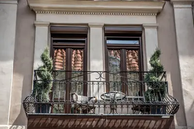 a balcony with a table and chairs on it at Boutique Guest house 7th Sense in Plovdiv