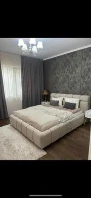 a large bed in a bedroom with a large bed frame at Guest House Amaya in Plovdiv