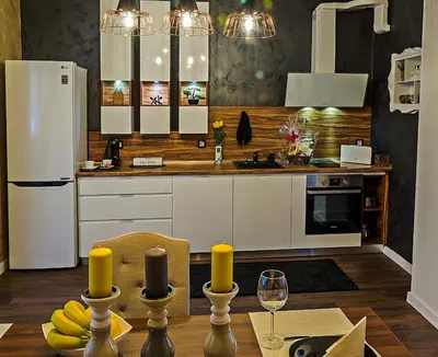 a kitchen with a white refrigerator and a table with bananas at Guest House Amaya in Plovdiv