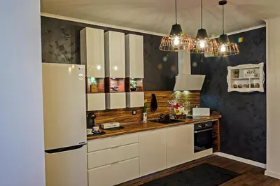 a kitchen with white cabinets and a white refrigerator at Guest House Amaya in Plovdiv