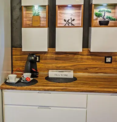 a counter with two cups and a tea time sign on it at Guest House Amaya in Plovdiv