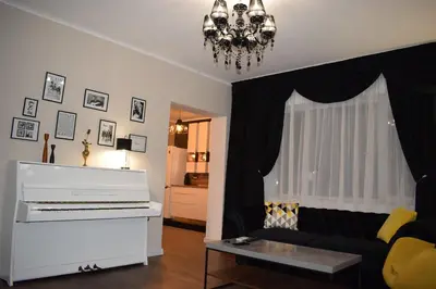 a living room with a piano and a couch at Guest House Amaya in Plovdiv