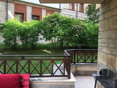 a balcony with a wooden fence and bushes at Snow Apartment - Bansko in Bansko