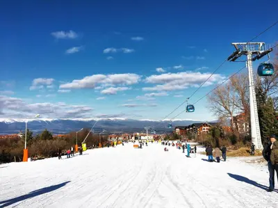 a group of people on a ski lift in the snow at Snow Apartment - Bansko in Bansko