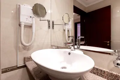 a bathroom with a white sink and a mirror at Downtown Bansko Resort in Bansko