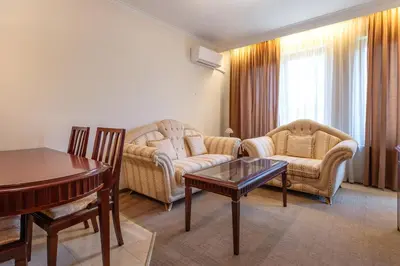 a living room with two chairs and a table at Downtown Bansko Resort in Bansko