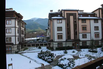 a group of buildings with snow on the ground at Downtown Bansko Resort in Bansko