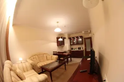 a living room with two couches and a tv at Downtown Bansko Resort in Bansko