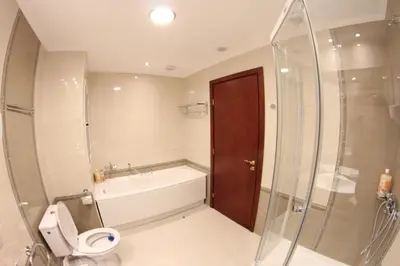 a bathroom with a tub and a toilet and a shower at Downtown Bansko Resort in Bansko