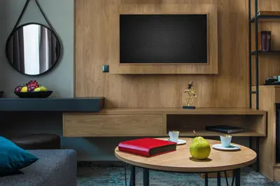 a living room with a table with a television at THE STAY Boutique Hotel Central Square - Free Compliments - Free Wi-Fi - TOP LOCATION - Nearby Paid Parking in Plovdiv