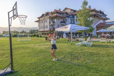a girl throwing a frisbee at a basketball hoop at Thermal Hotel Seven Seasons in Banya