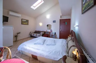 a hospital room with a bed and a couch at Guesthouse Elizabeth in Samokov