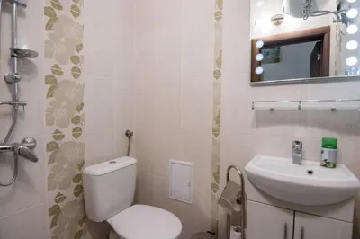 a bathroom with a toilet and a sink at The Balkan in Plovdiv